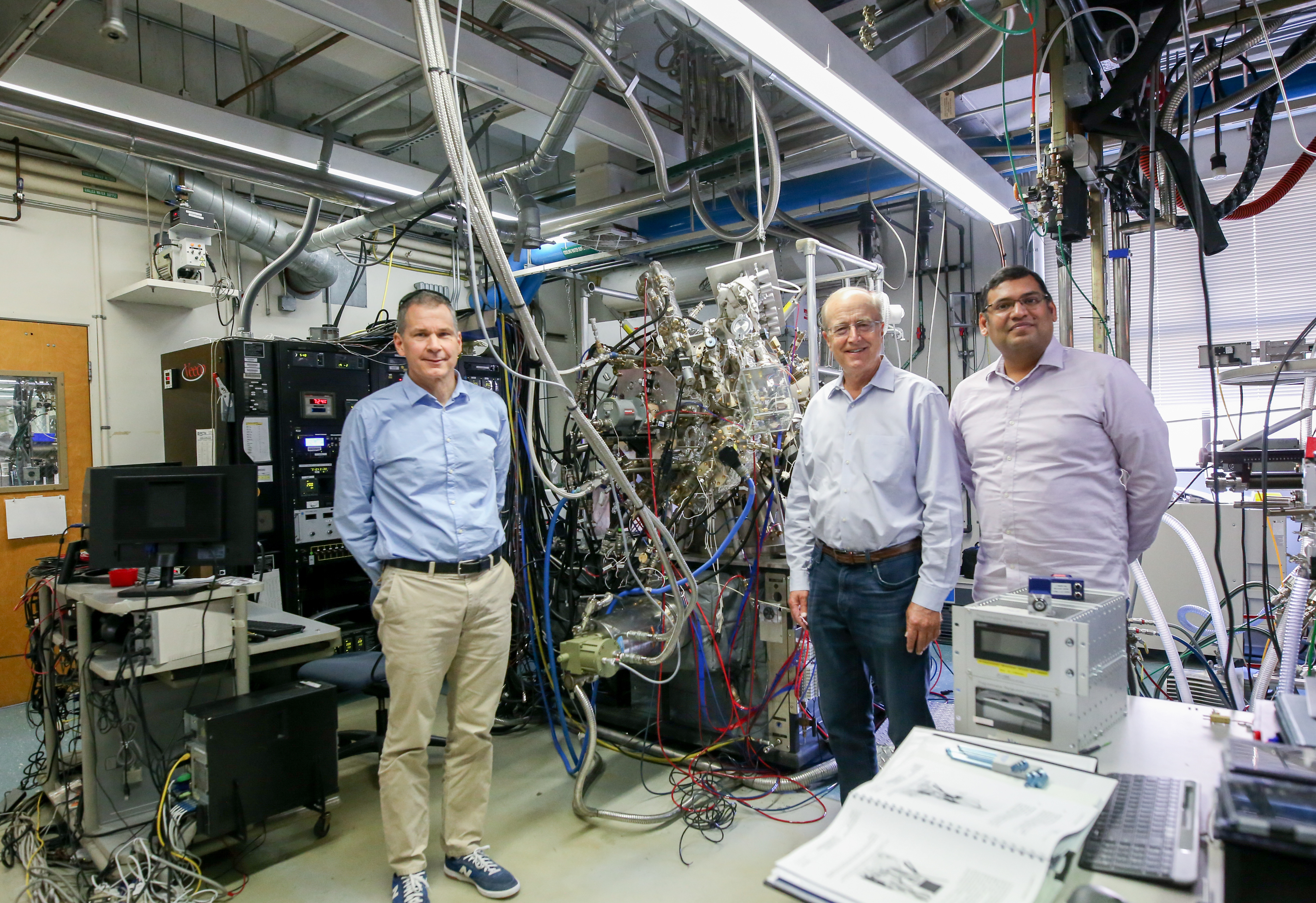 Jim Speck, John Bowers, and Sriram Krishnamoorthy standing in front of lab equipment