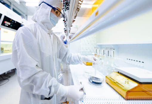 Person wearing hazmat suit in a lab