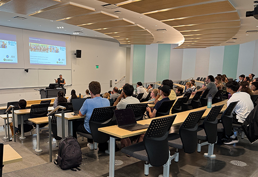 Data Driven Biology Trainee Artury Ramirez presents his research on anaerobic gut fungi inside a lecture hall. 