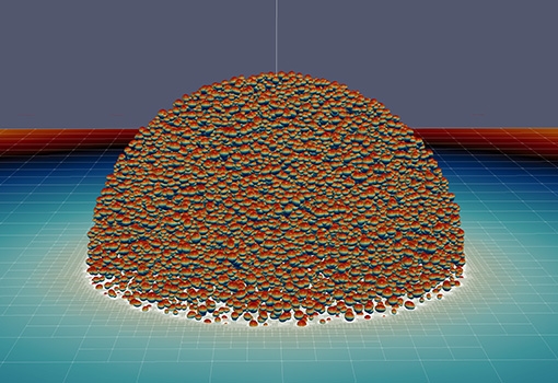   An image from the simulation of a large, spherical cluster of cells responding to an electric pulse. Cells in the aggregate are color-coded by their transmembrane potential (hotter colors on cells imply higher transmembrane potential). The equatorial slice is to illustrate some of the computational techniques used for solving bioelectric interactions on the cell membranes.