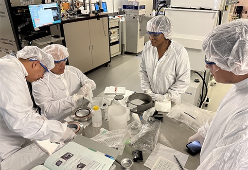 Students receive instruction about caring for an instrument in the Quantum Structures Facility at UCSB