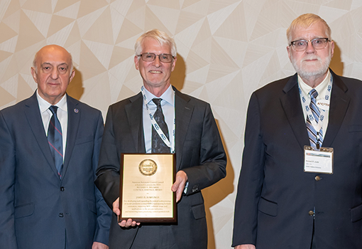 UCSB chemical engineering professorJames Rawlings, pictured in center, holds awards plaque during national conference