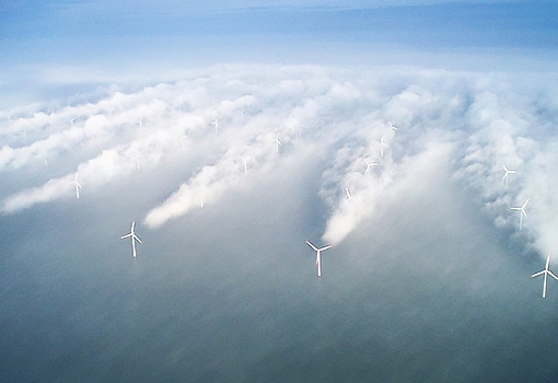 Turbines spinning in fog at an offshore wind farm reveal the wind shadows the big blades cause. Photo by Vattenfall 