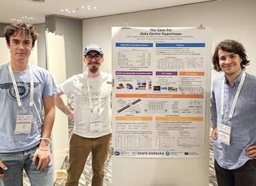 Jonathan Balkind (center) and student co-lead authors (from left), Isaac Hair and Guillem López-Paradis with the poster of the paper they presented at the International Symposium on Computer Architecture.